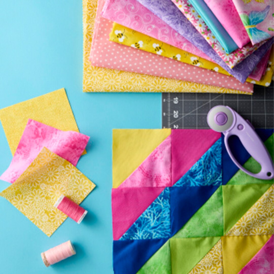 quilt fabric squares with template and rotary scissors